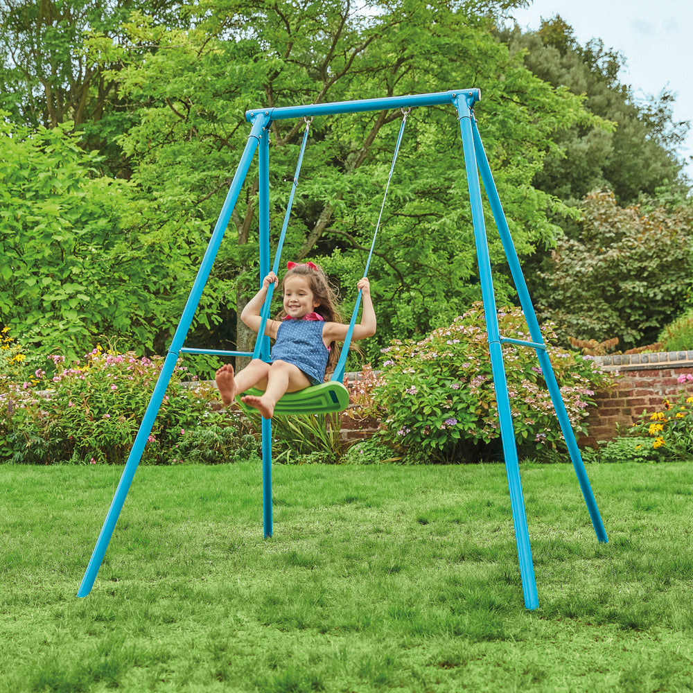 Child swinging on single metal swing set