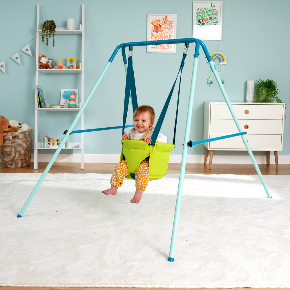 Baby swinging in a toddler swing seat