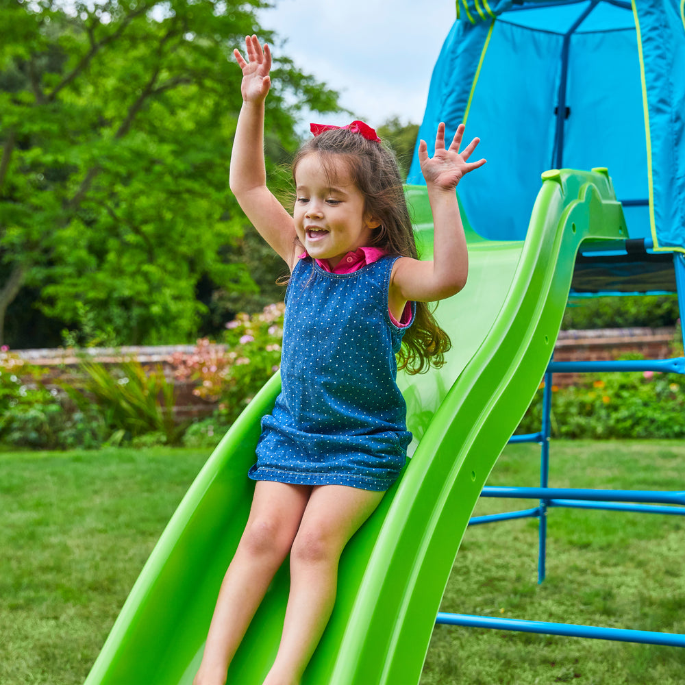 Child sliding down garden slide