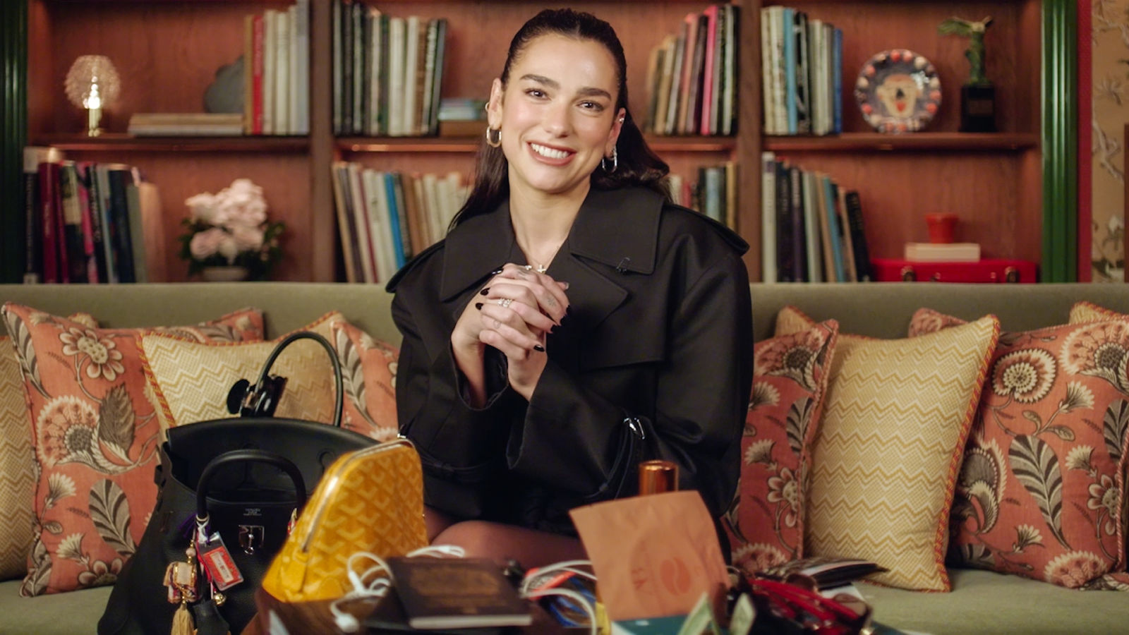 Books, Hot Sauce, and Tangled Headphones: Inside Dua Lipa’s “Chaotic” Birkin Bag